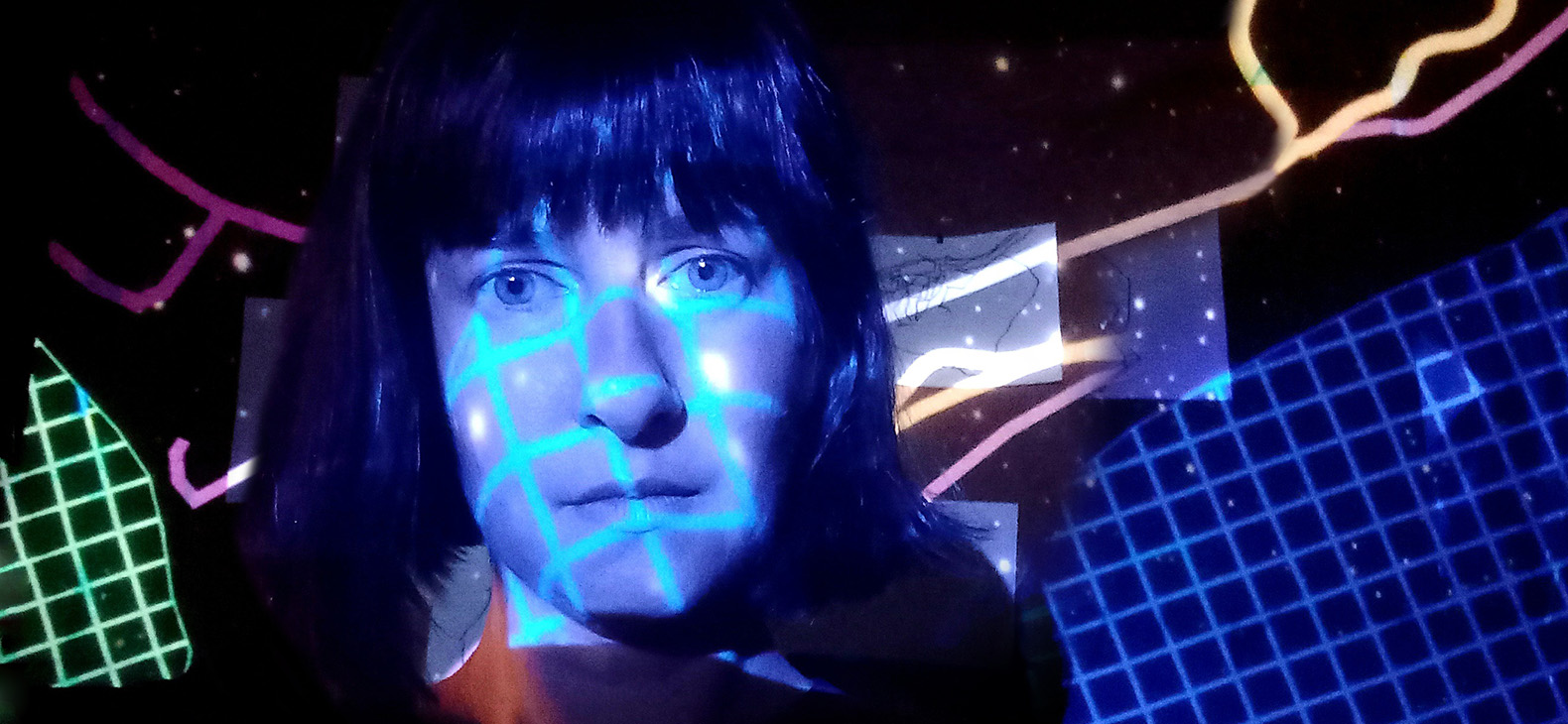 Portrait of the artist Beata Kolbasovska. Colorful grids of light are projected onto her face and the background, which are blue, green, pink or yellow. 